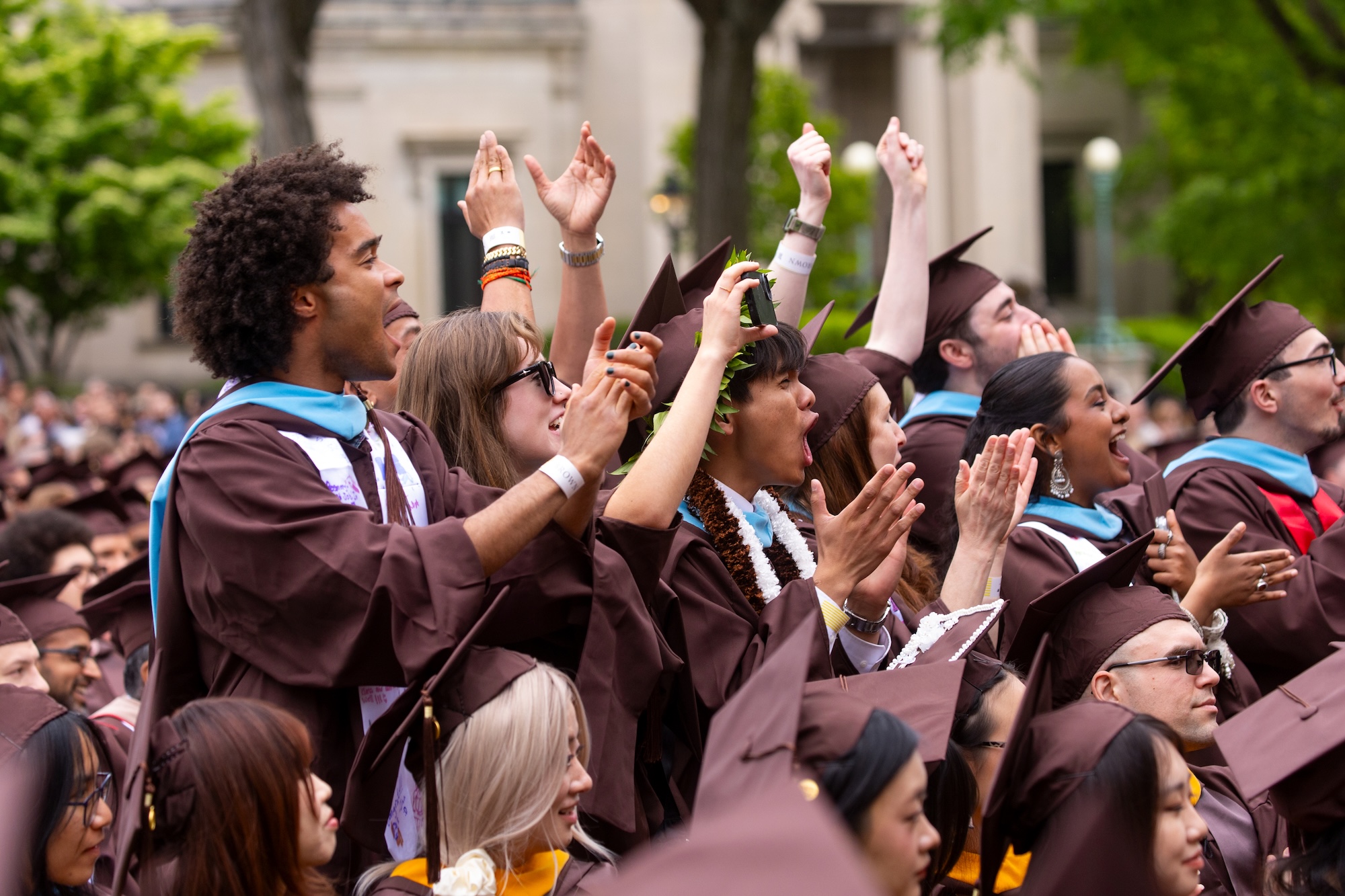 Students from the IE Brown Executive MBA program cheering at Commencement.